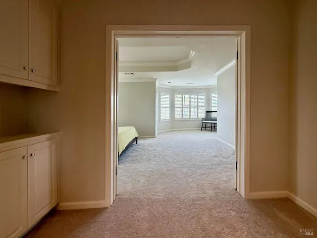 a bed sitting in a room next to a window