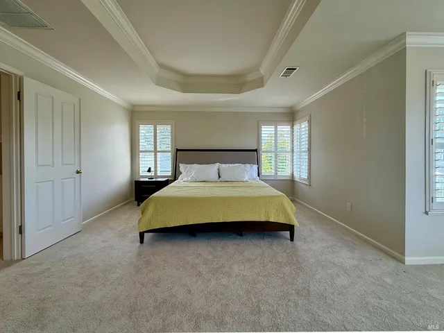 a large white kitchen with a large window