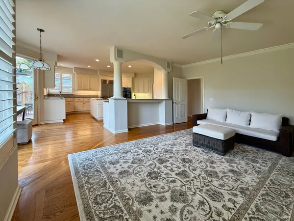 a living room with a couch and wooden floor