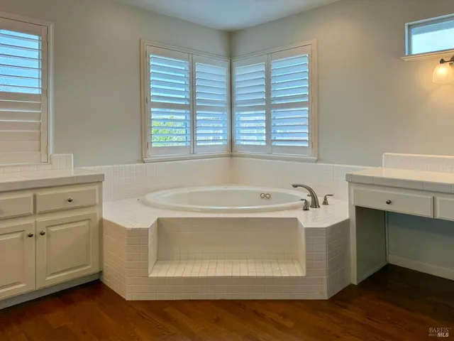 a view of a hallway with wooden floor and closet