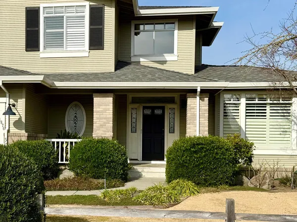 a front view of a house with garden