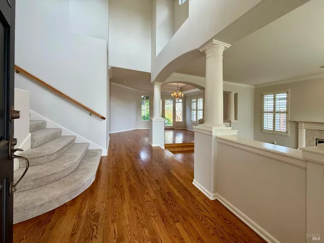 a view of a living room and kitchen with wooden floor