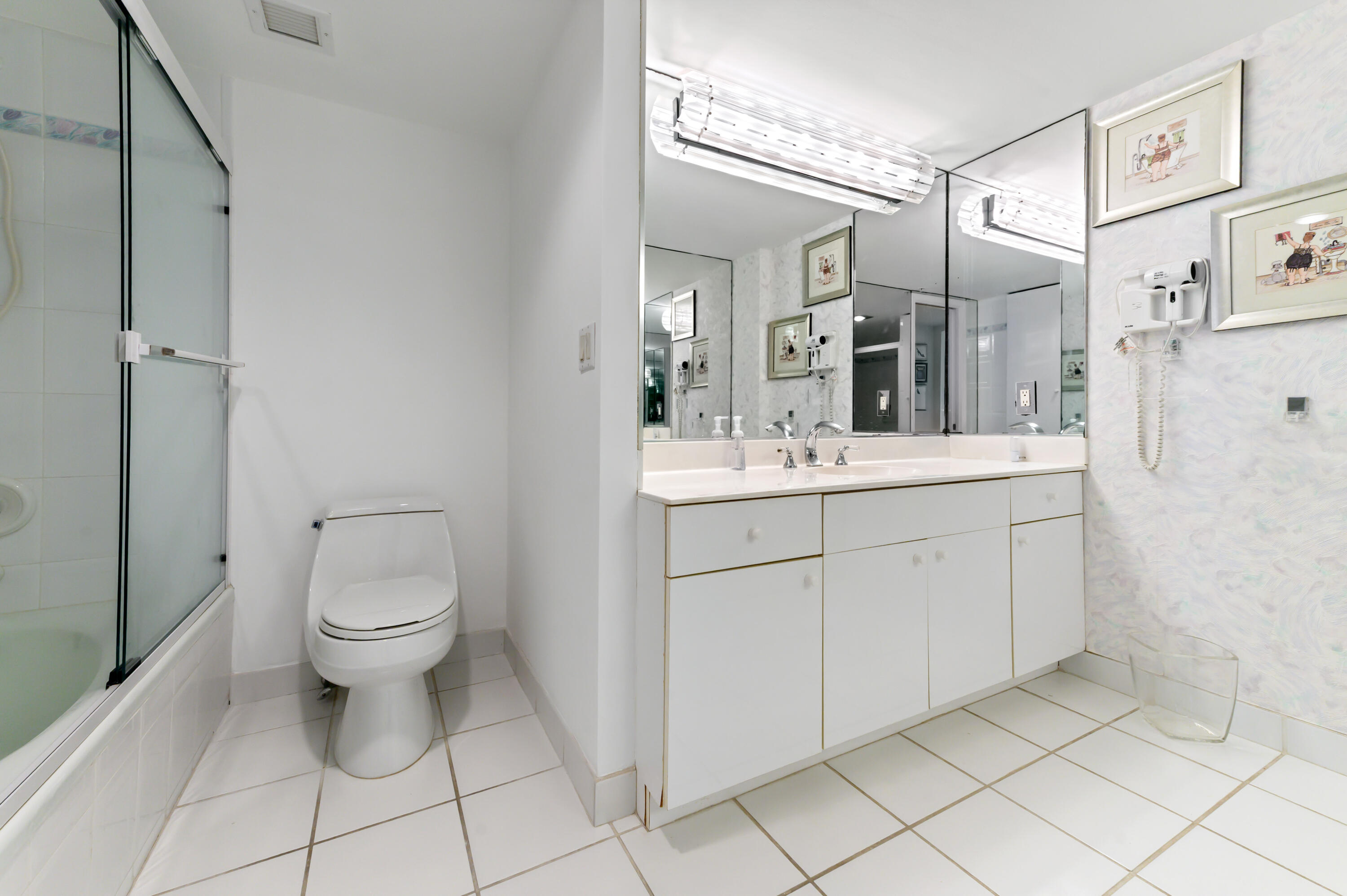 2600 South Ocean Boulevard, Unit 3E Boca Raton, FL 33432 - Photo 20 of 56 a spacious bathroom with a toilet sink and a mirror