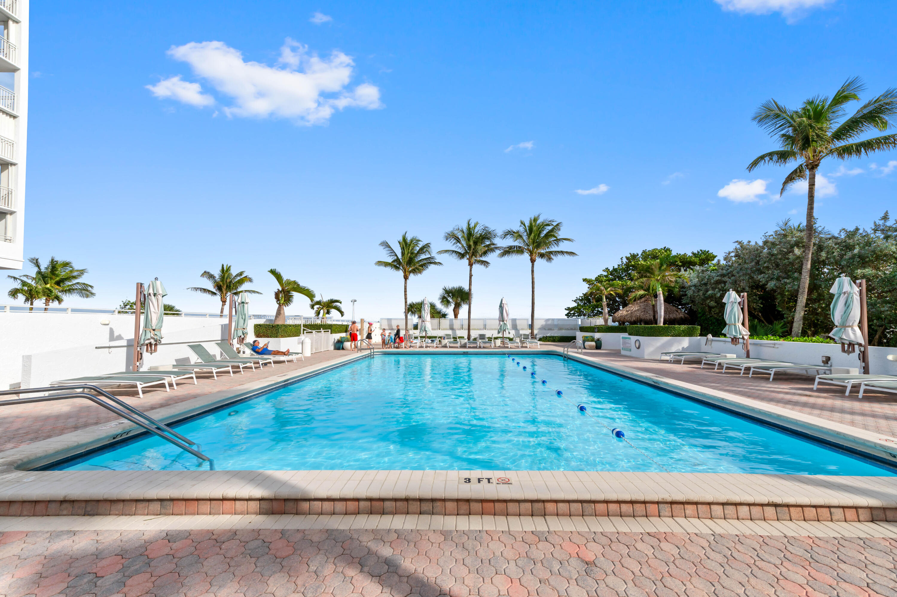 2600 South Ocean Boulevard, Unit 3E Boca Raton, FL 33432 - Photo 43 of 56 a view of a swimming pool with a lounge chair