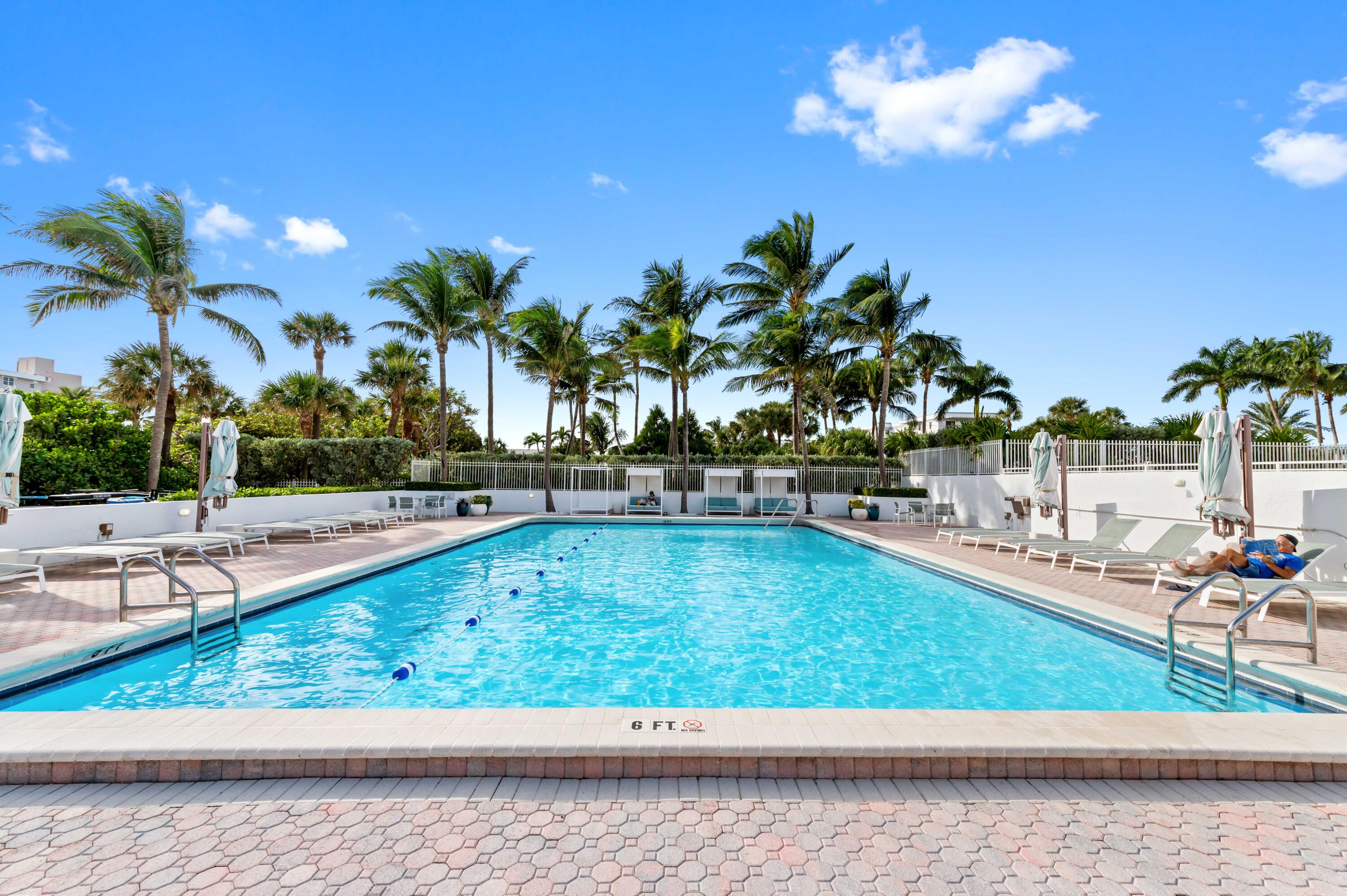 2600 South Ocean Boulevard, Unit 3E Boca Raton, FL 33432 - Photo 45 of 56 a view of a swimming pool with lounge chair