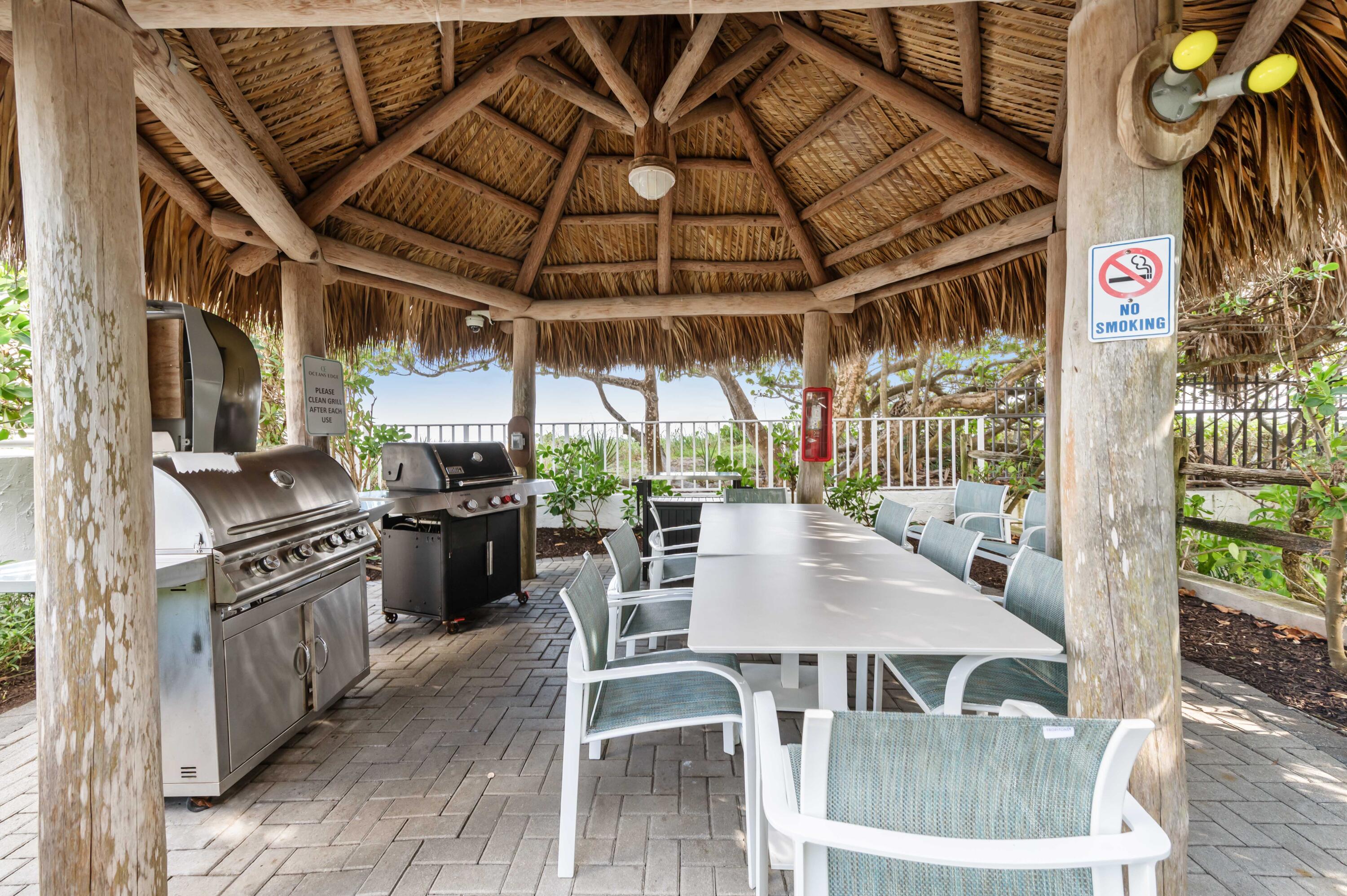 2600 South Ocean Boulevard, Unit 3E Boca Raton, FL 33432 - Photo 47 of 56 a view of a patio with table and chairs with wooden floor and fence