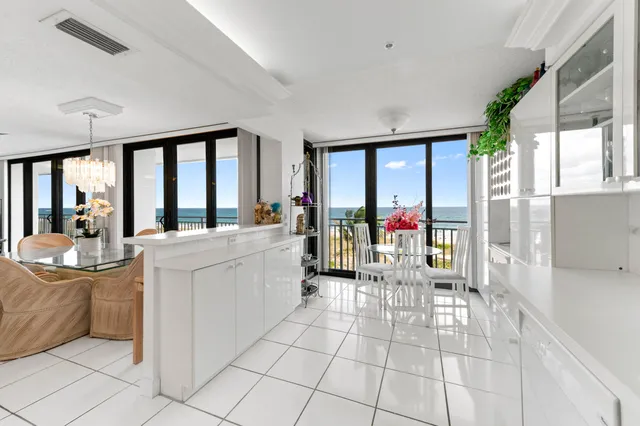 a bedroom with a large bed and a potted plant