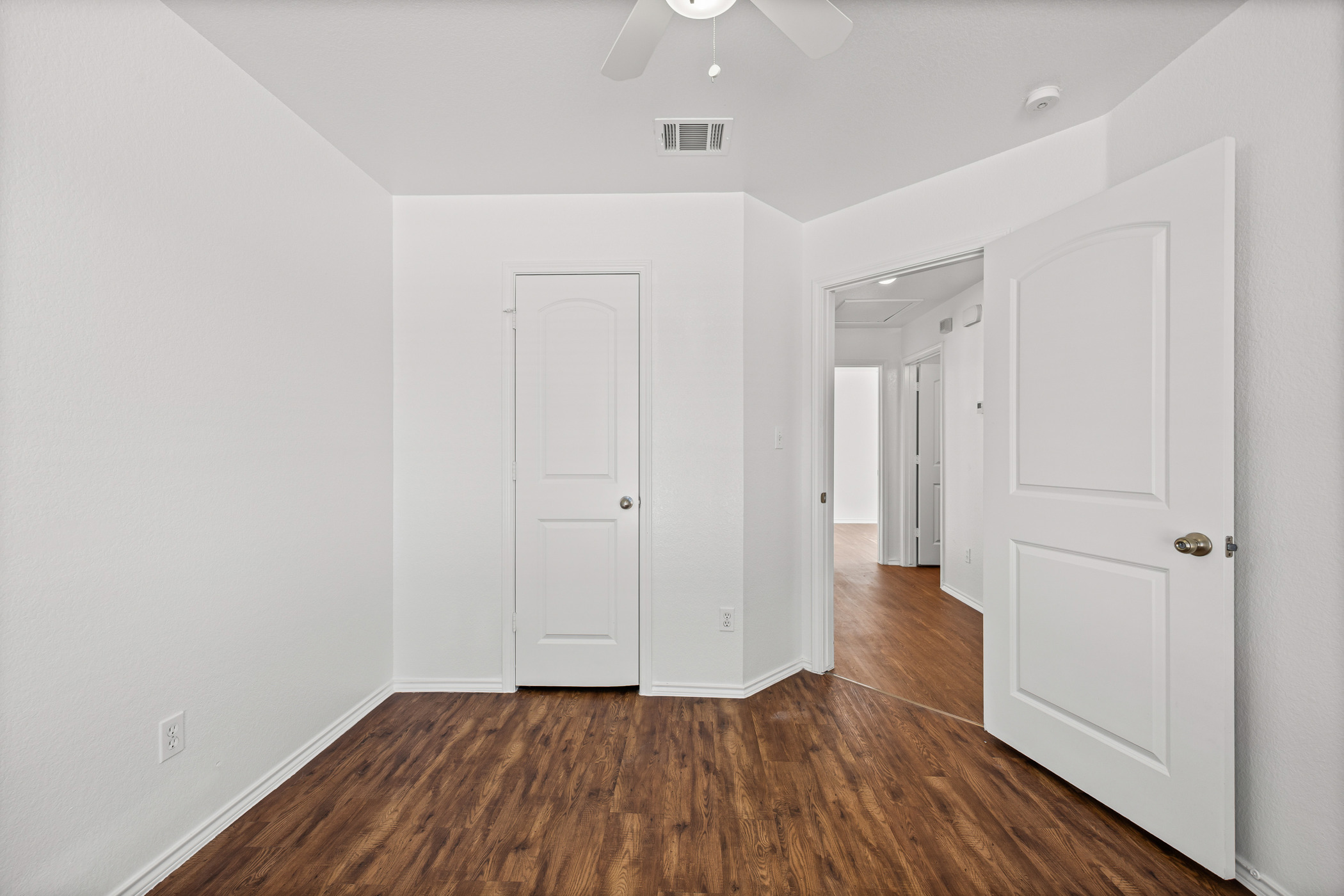 4503 Halliday Avenue Austin, TX 78725 - Photo 12 of 21 Unfurnished bedroom featuring dark wood-type flooring and ceiling fan