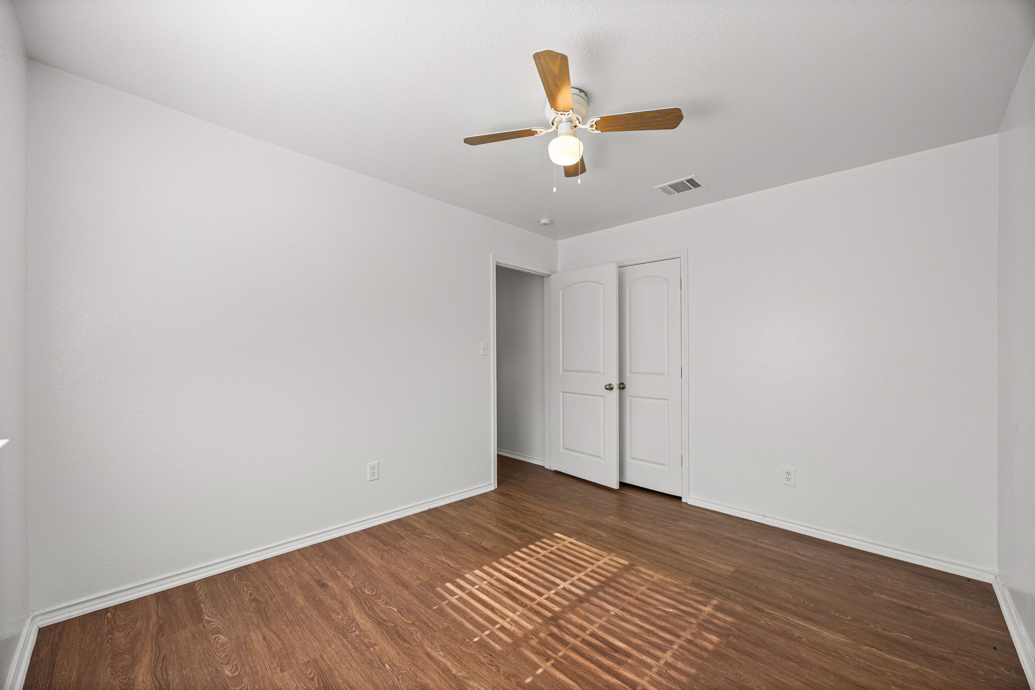 4503 Halliday Avenue Austin, TX 78725 - Photo 17 of 21 Unfurnished bedroom featuring dark wood finished floors and ceiling fan