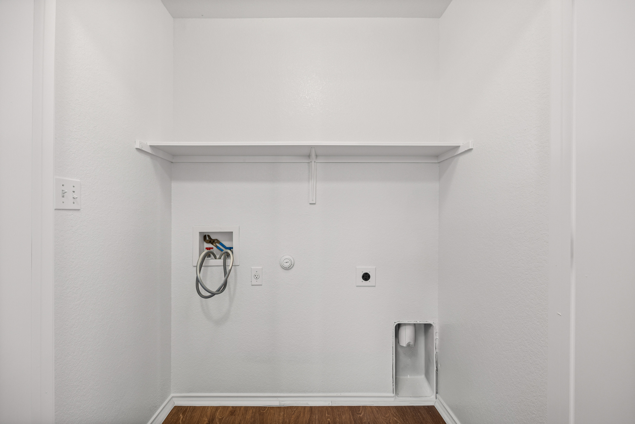 4503 Halliday Avenue Austin, TX 78725 - Photo 18 of 21 Laundry room with gas dryer hookup, dark wood-style flooring, hookup for a washing machine, and electric dryer hookup
