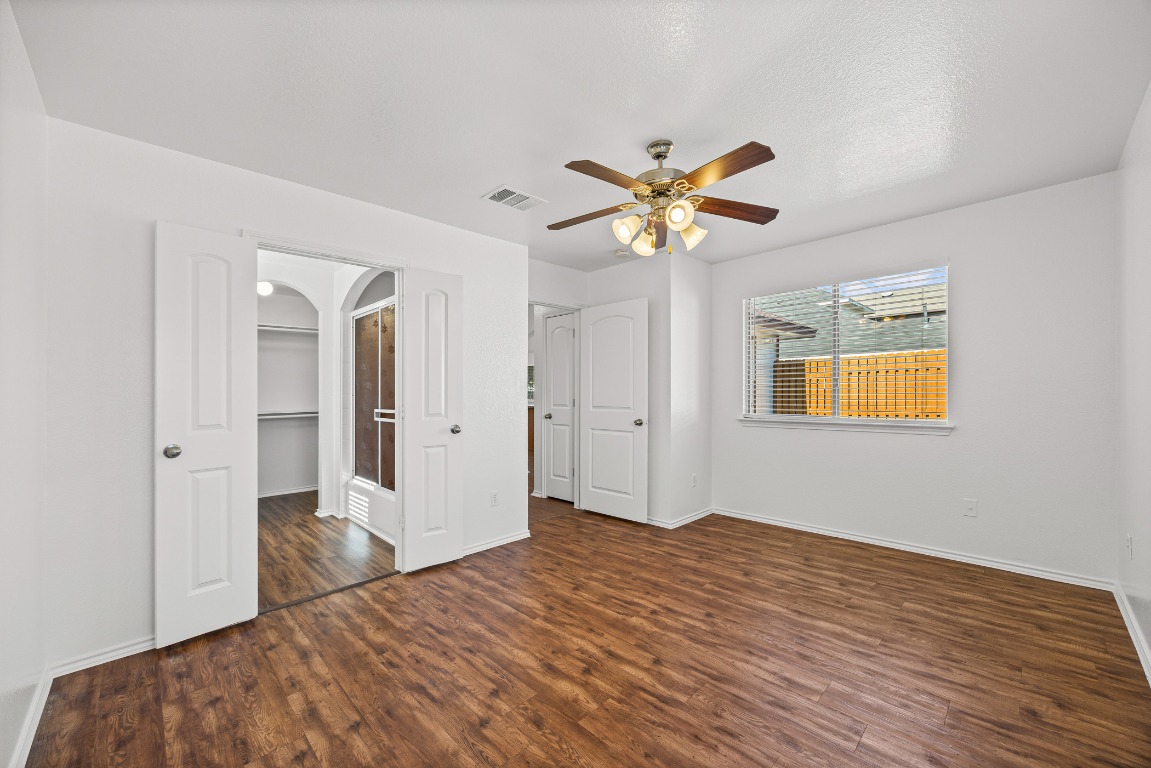 4503 Halliday Avenue Austin, TX 78725 - Photo 20 of 21 a bedroom with a bed and a chandelier