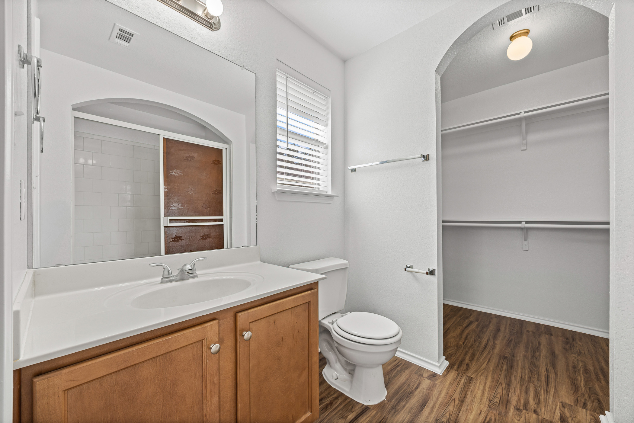 4503 Halliday Avenue Austin, TX 78725 - Photo 21 of 21 Full bath with vanity, a walk in closet, and dark wood-type flooring