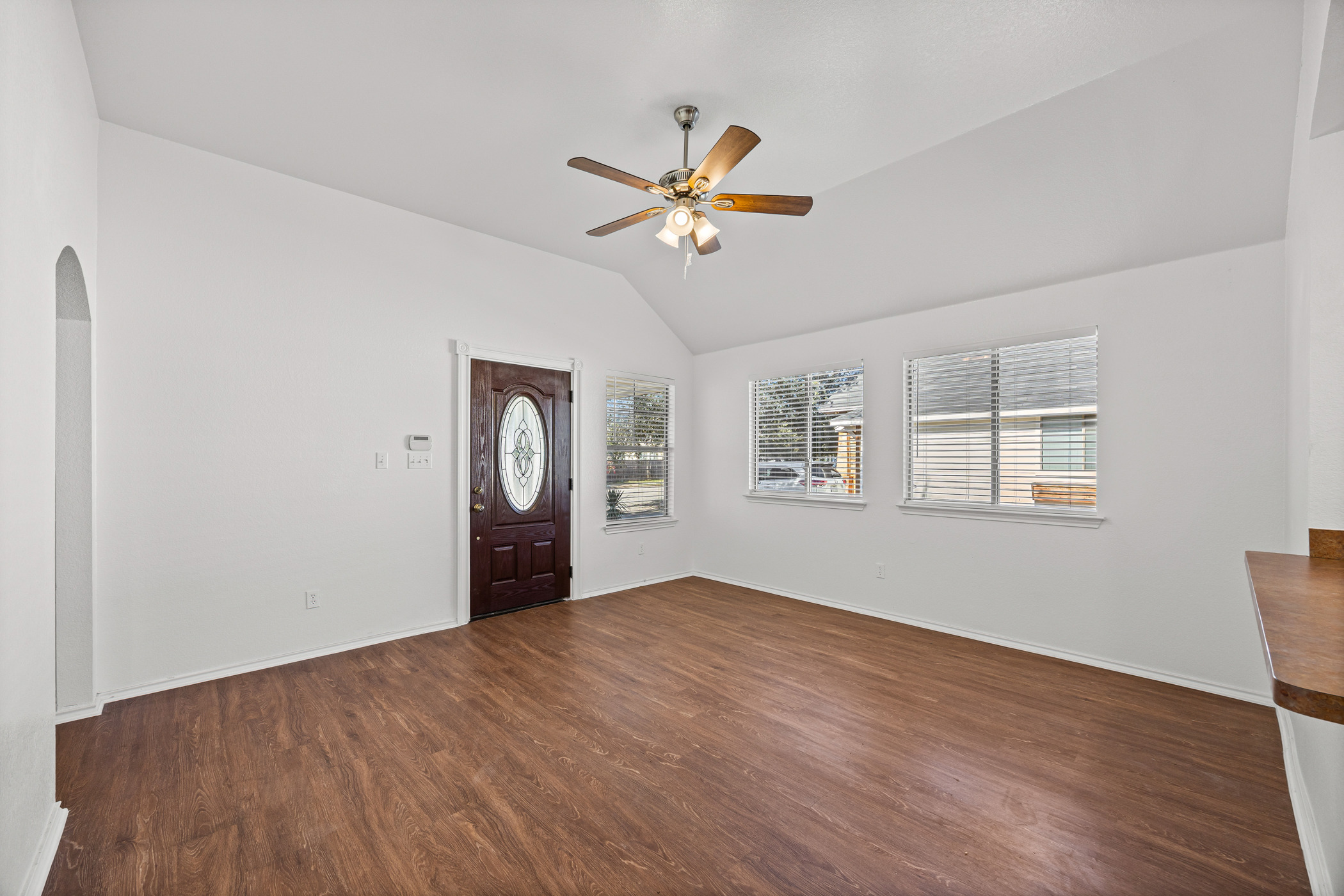 4503 Halliday Avenue Austin, TX 78725 - Photo 6 of 21 Foyer entrance with lofted ceiling, dark wood-type flooring, ceiling fan, and arched walkways