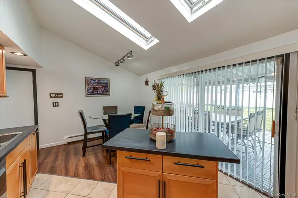 a dining room with furniture and wooden floor