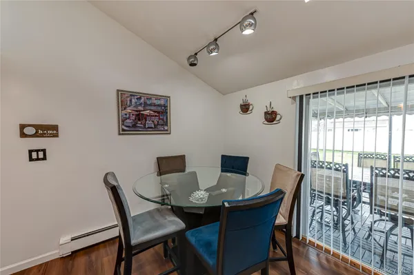 a view of a dining room with furniture and wooden floor