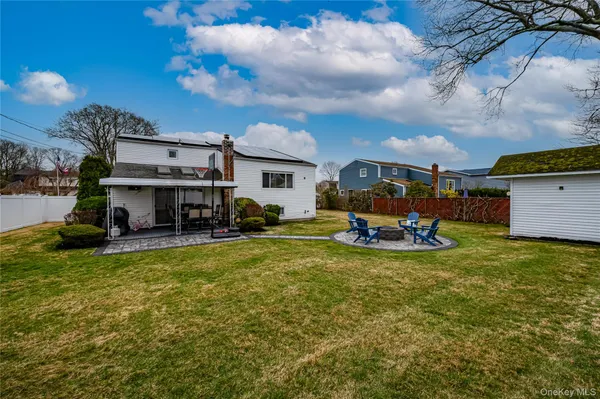 a view of a house with swimming pool and furniture