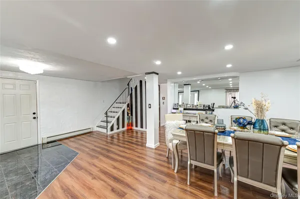 a dining room with furniture and a kitchen view