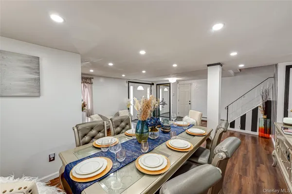 a dining room with lots of furniture and wooden floor