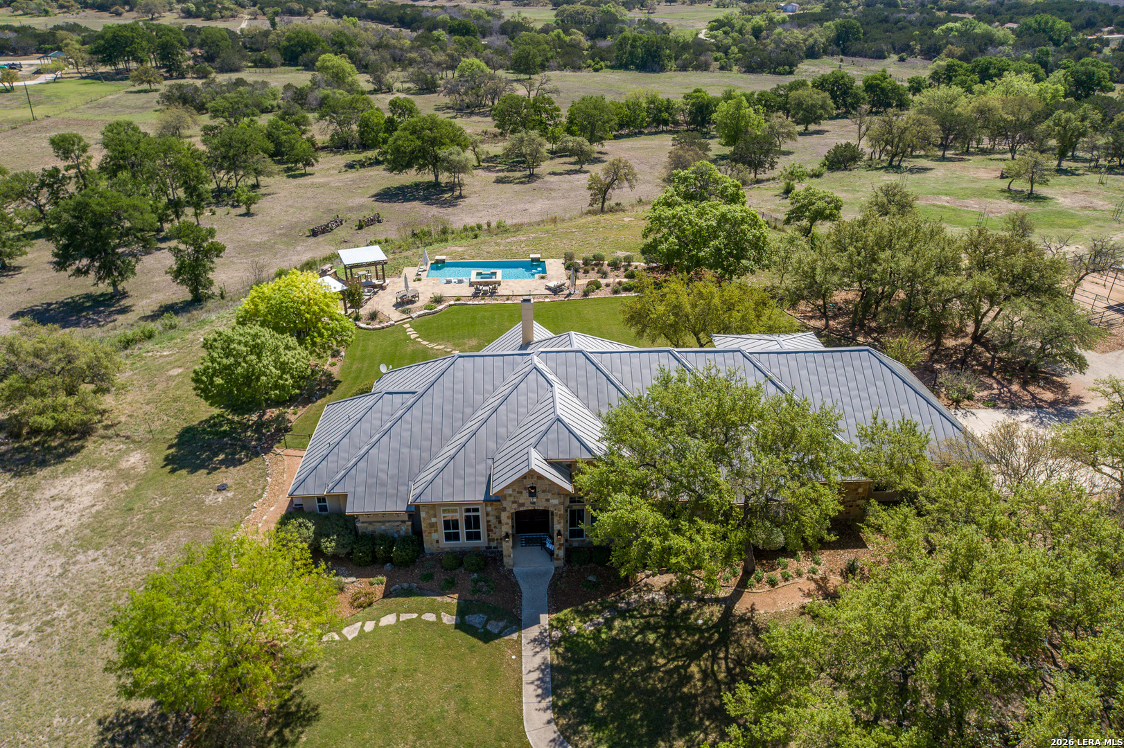 395 Bluff Creek Road North Center Point, TX 78010 - Photo 1 of 50 an aerial view of a house with a yard and lake view