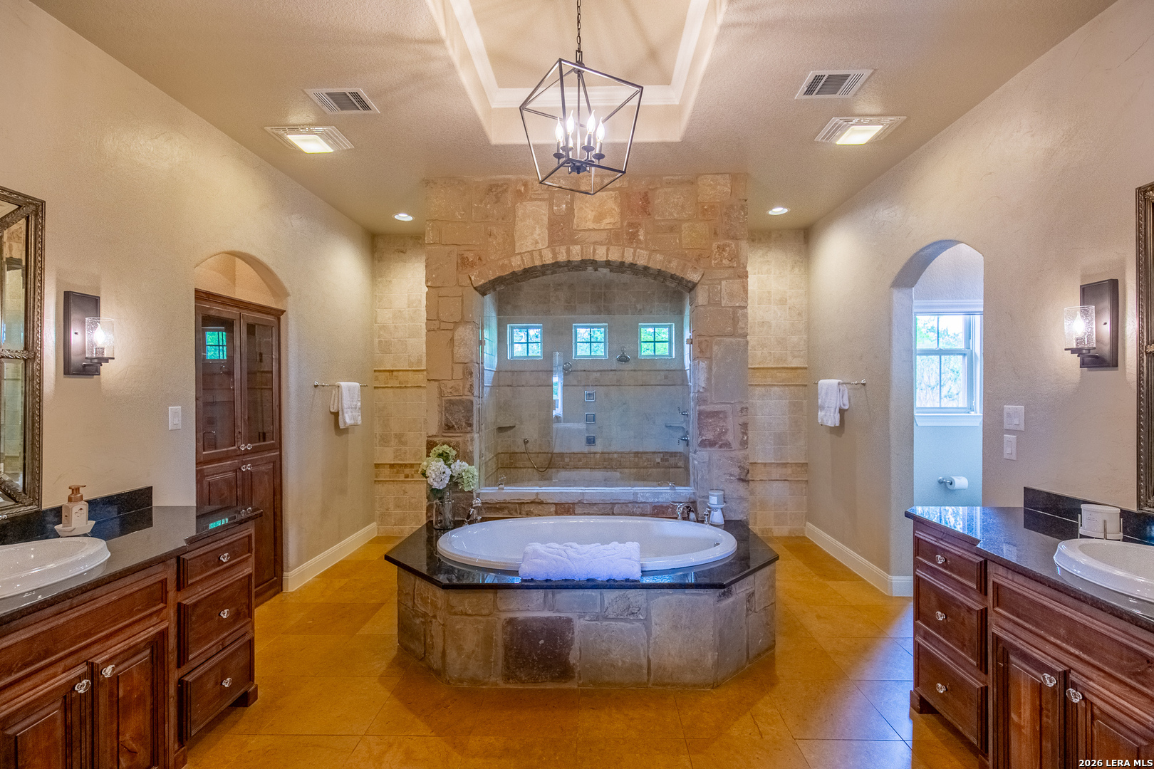 395 Bluff Creek Road North Center Point, TX 78010 - Photo 12 of 50 a spacious bathroom with a sink a large mirror and a shower