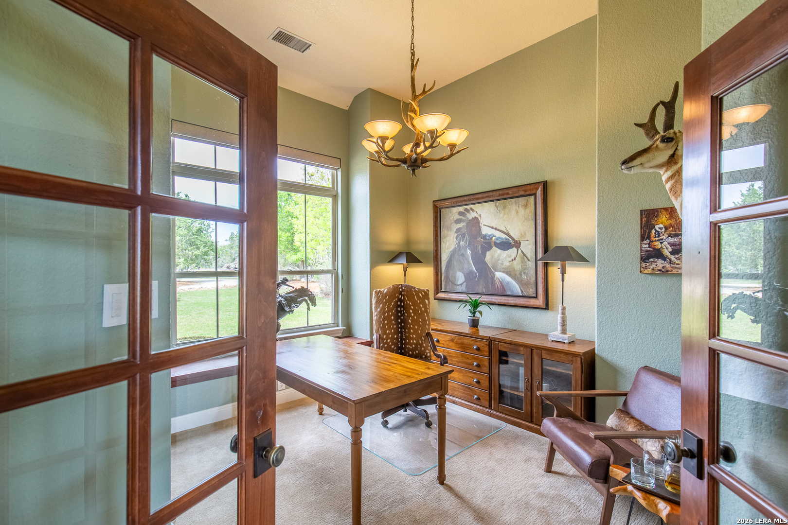 395 Bluff Creek Road North Center Point, TX 78010 - Photo 13 of 50 a view of a dining room with furniture a chandelier and a window
