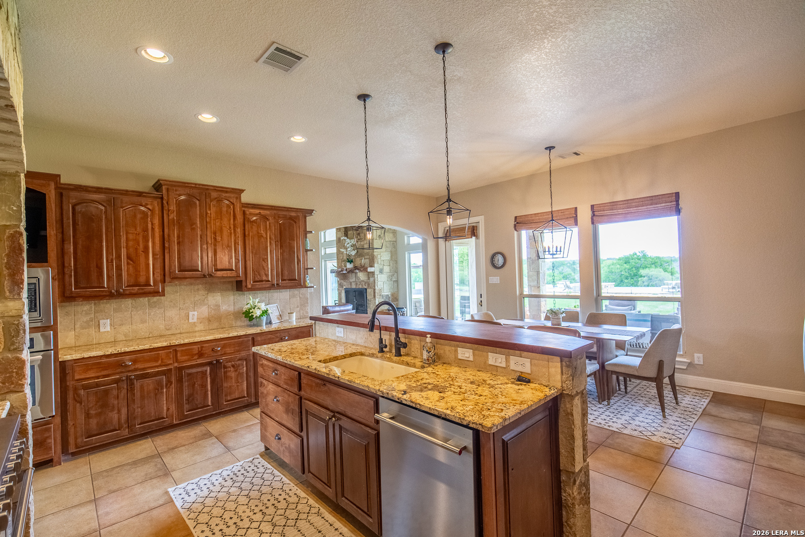 395 Bluff Creek Road North Center Point, TX 78010 - Photo 16 of 50 a kitchen with a sink window and chairs
