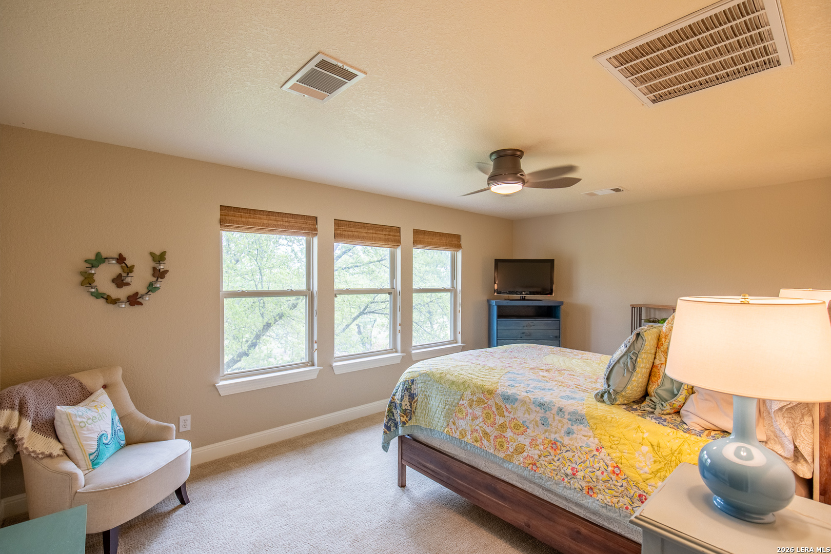 395 Bluff Creek Road North Center Point, TX 78010 - Photo 20 of 50 a bedroom with a bed and wooden floor