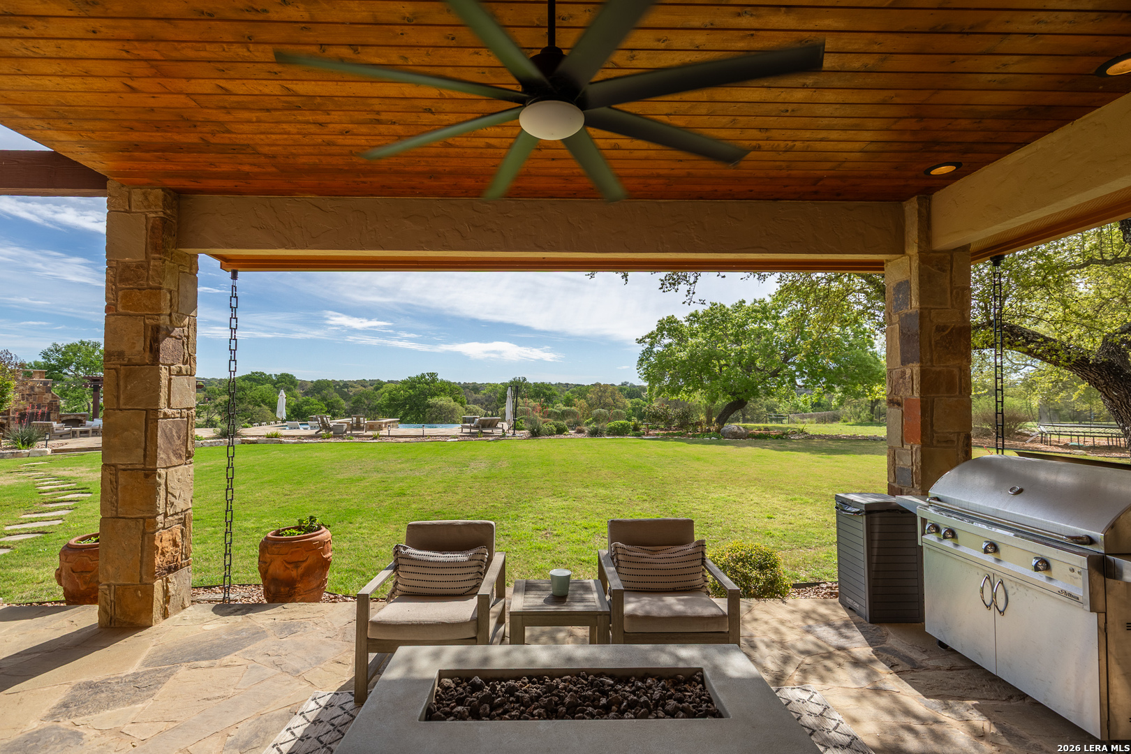 395 Bluff Creek Road North Center Point, TX 78010 - Photo 21 of 50 a view of a patio with a table chairs and a table