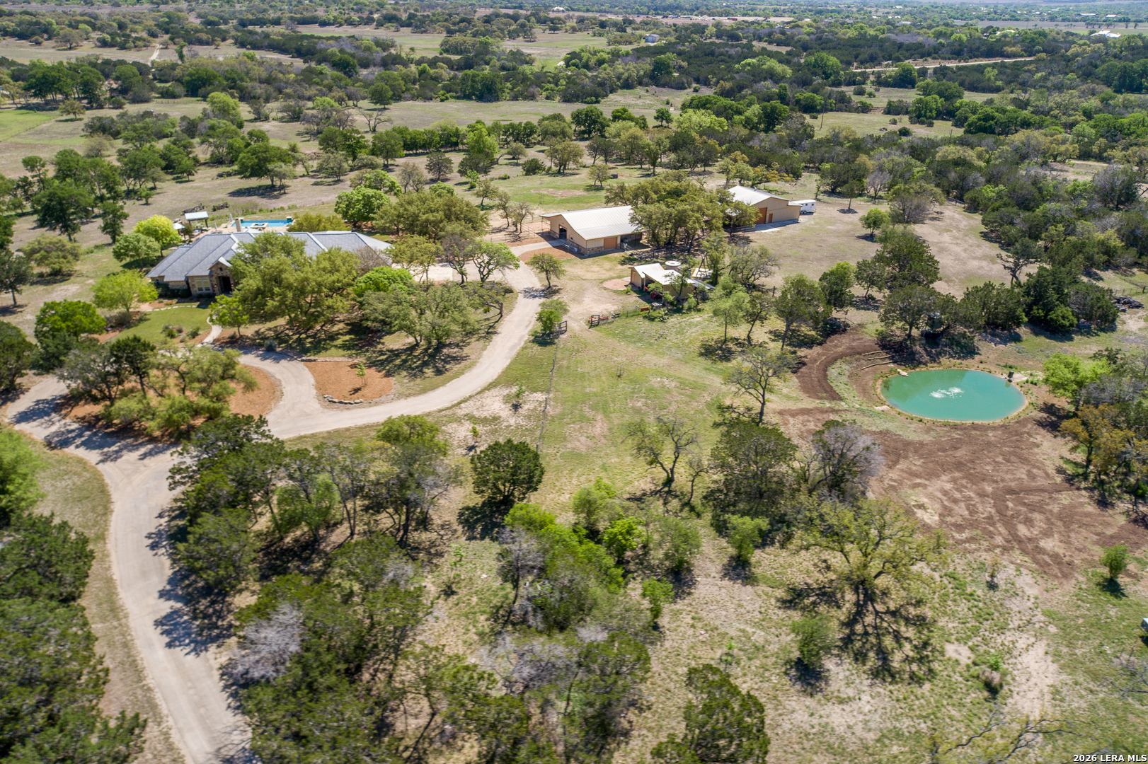 395 Bluff Creek Road North Center Point, TX 78010 - Photo 3 of 50 an aerial view of residential house with residential space and swimming pool