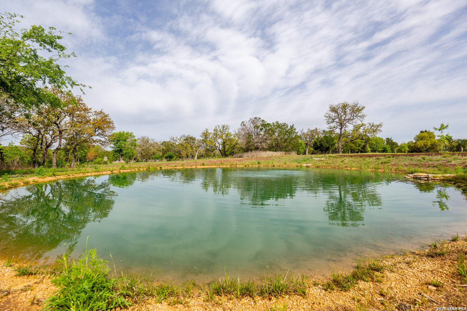 395 Bluff Creek Road North Center Point, TX 78010 - Photo 4 of 50 a view of a lake with houses in the background
