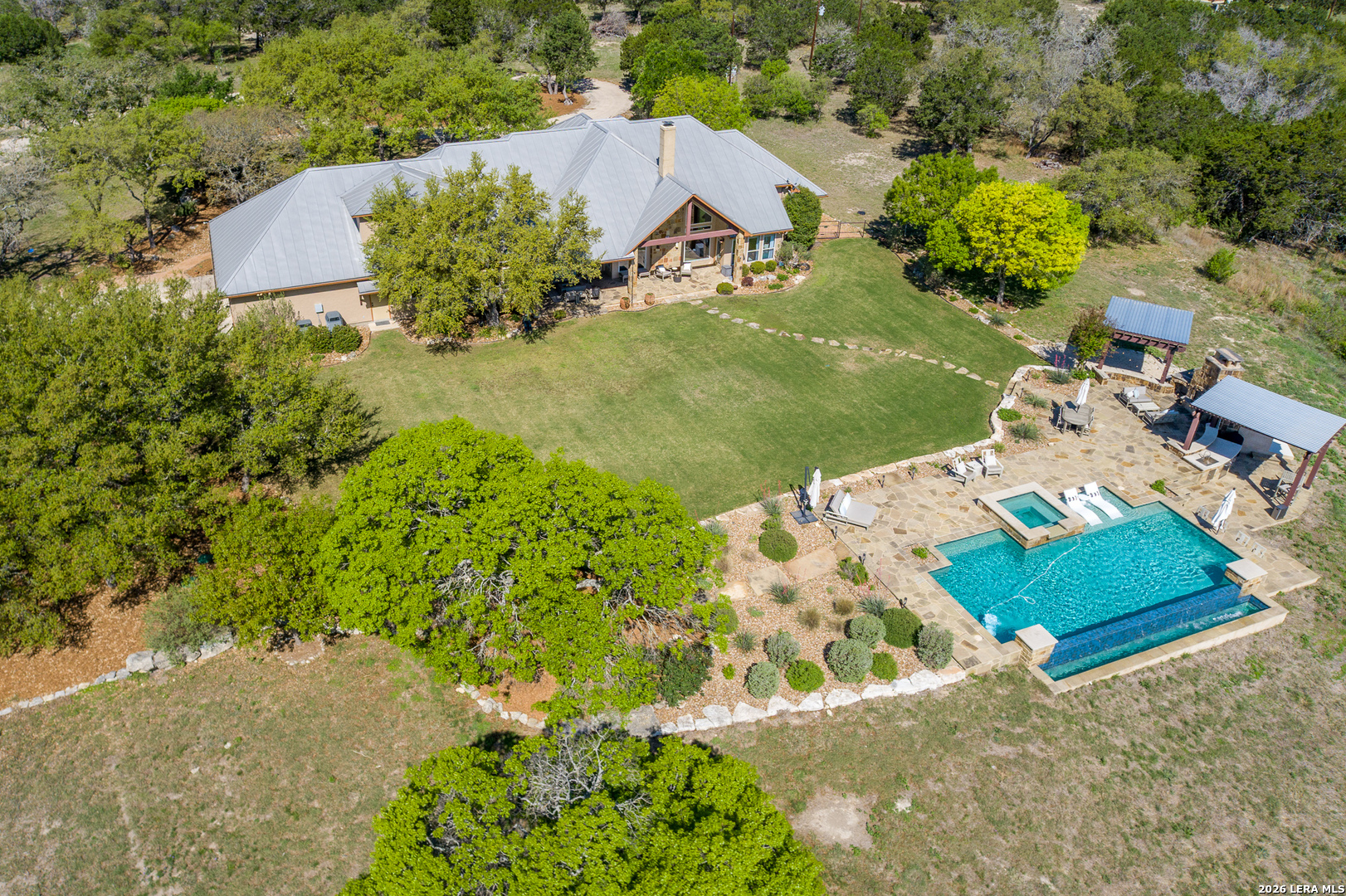 395 Bluff Creek Road North Center Point, TX 78010 - Photo 6 of 50 an aerial view of a house with a yard and lake view
