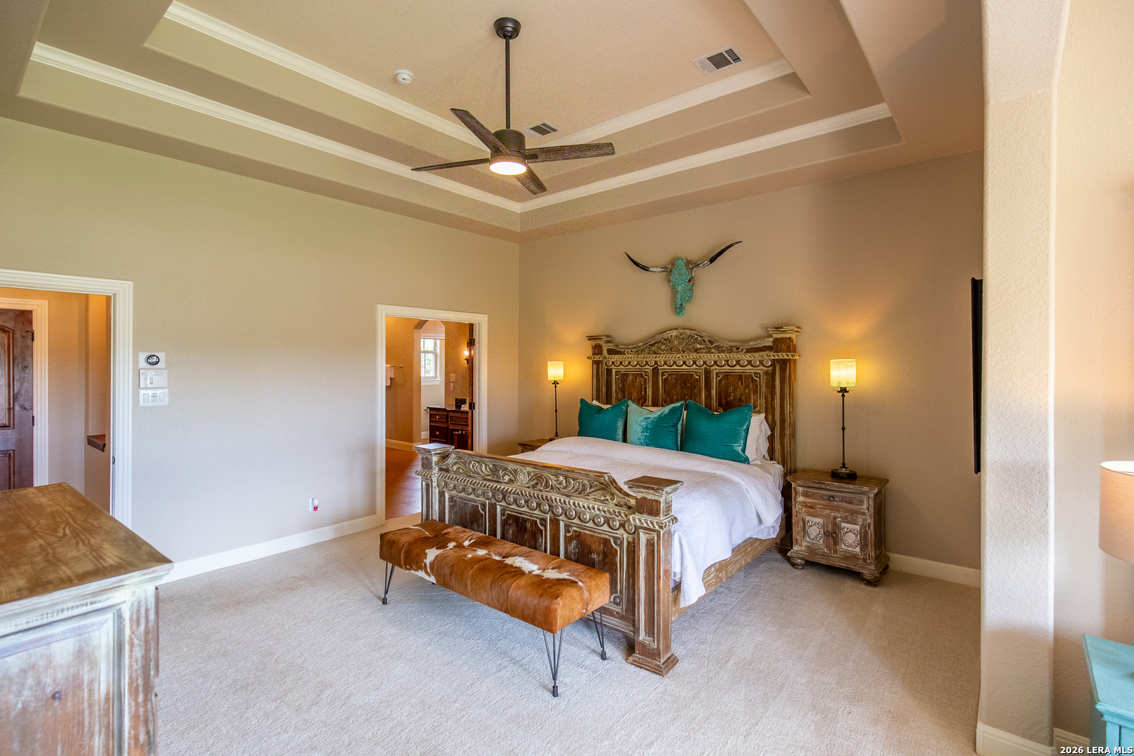 395 Bluff Creek Road North Center Point, TX 78010 - Photo 10 of 50 a bedroom with a bed and a chandelier