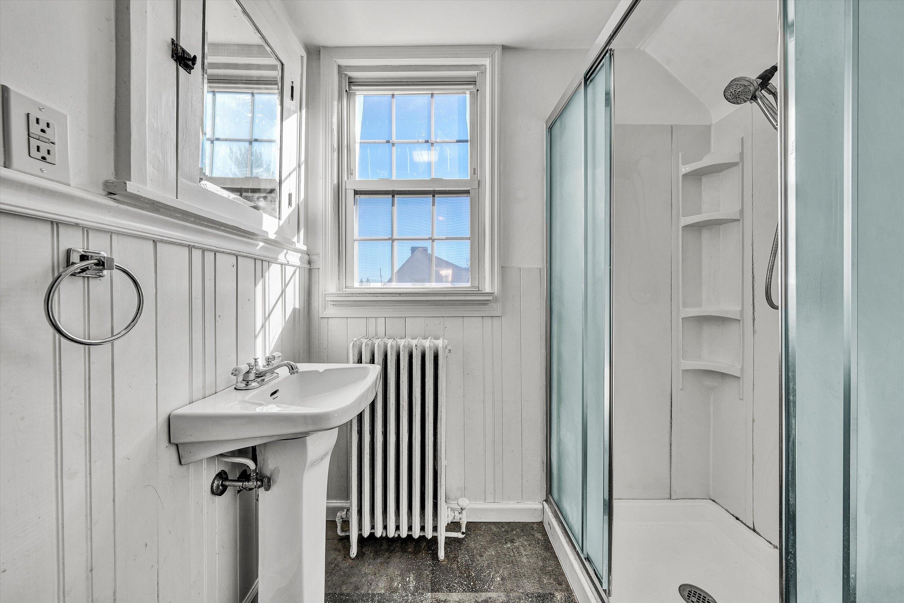 810 Windsor Avenue Southwest Roanoke, VA 24015 - Photo 15 of 21 a bathroom with a sink a mirror and a shower