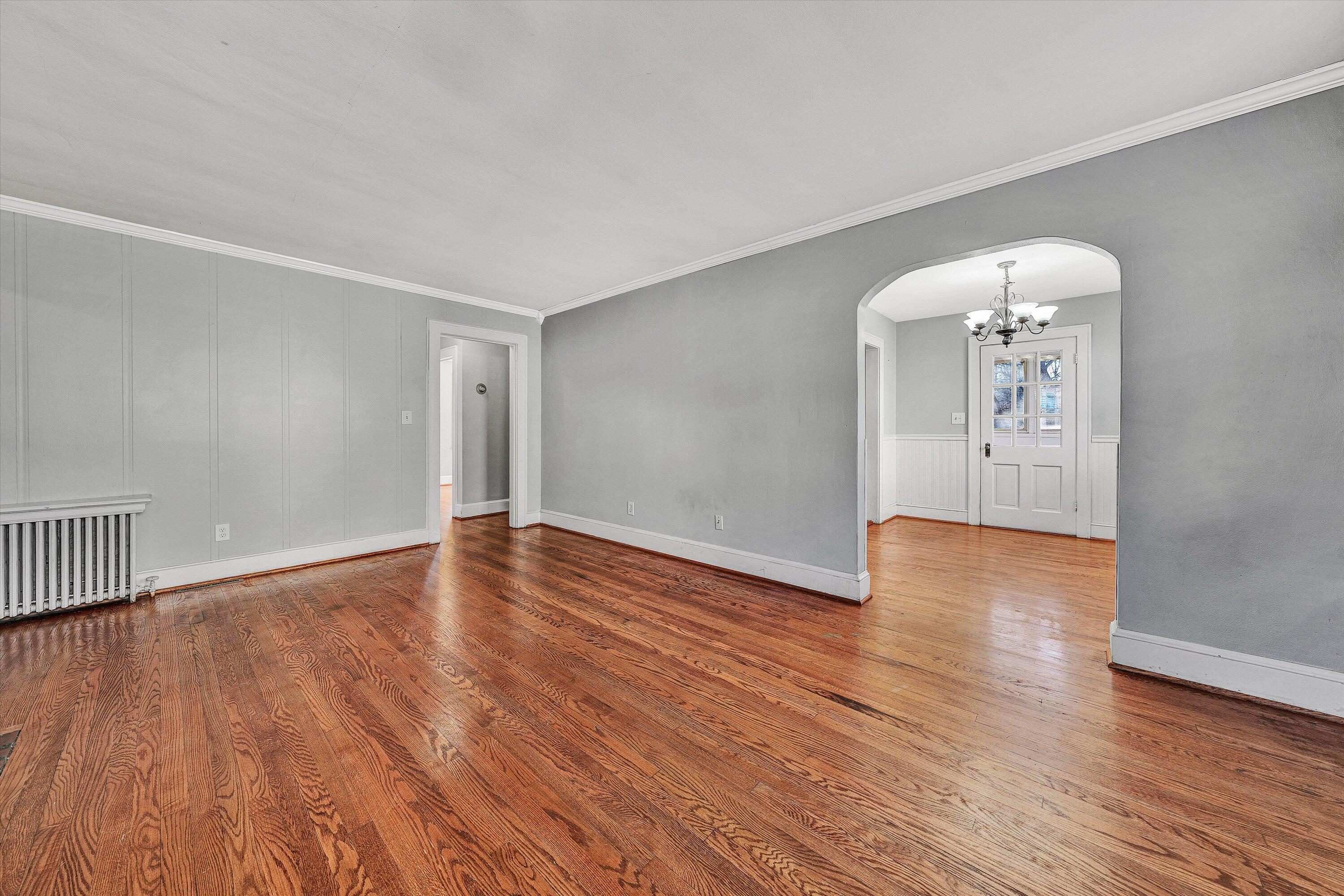 810 Windsor Avenue Southwest Roanoke, VA 24015 - Photo 4 of 21 an empty room with wooden floor and mirror