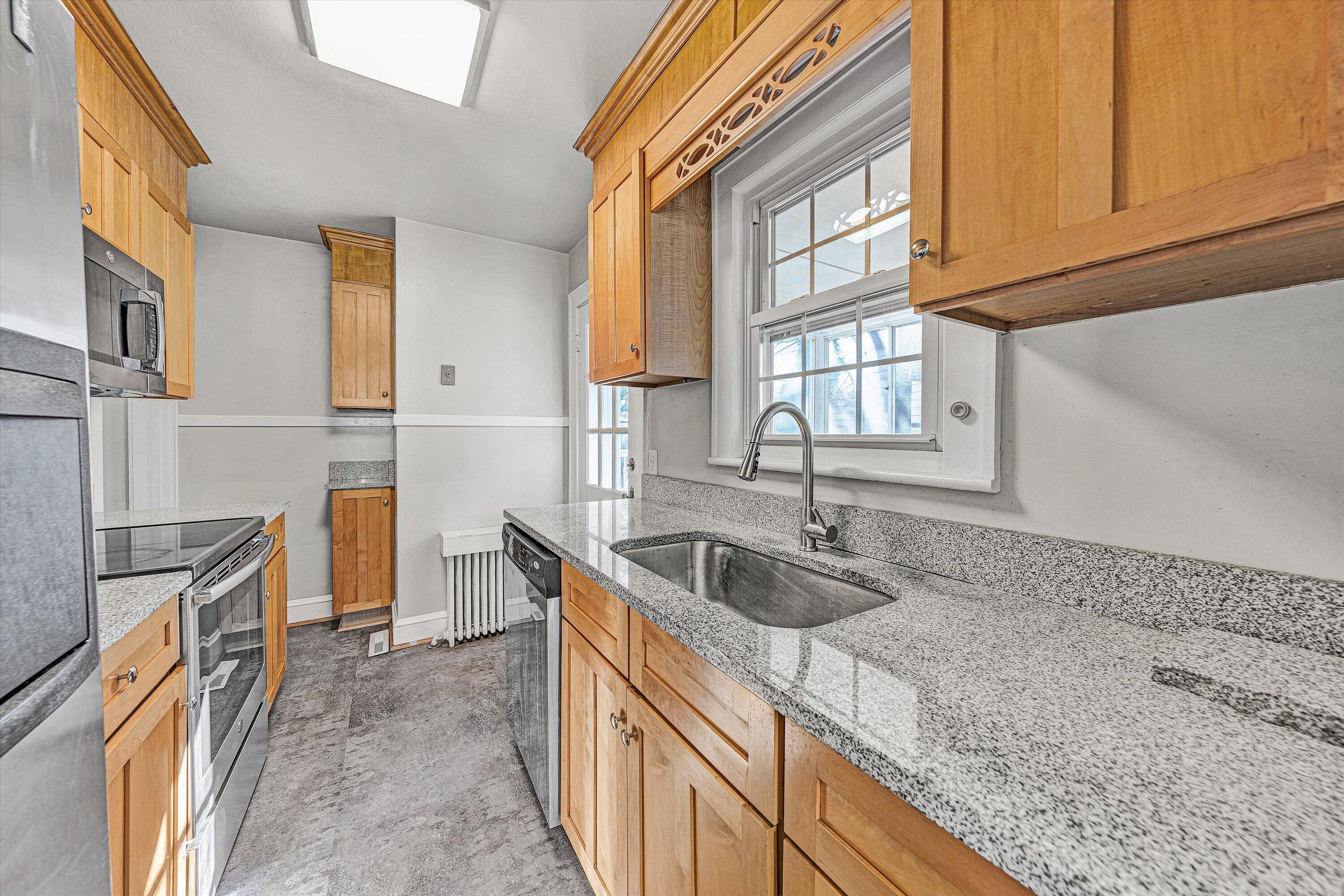810 Windsor Avenue Southwest Roanoke, VA 24015 - Photo 6 of 21 a kitchen with stainless steel appliances granite countertop a sink and a granite counter tops