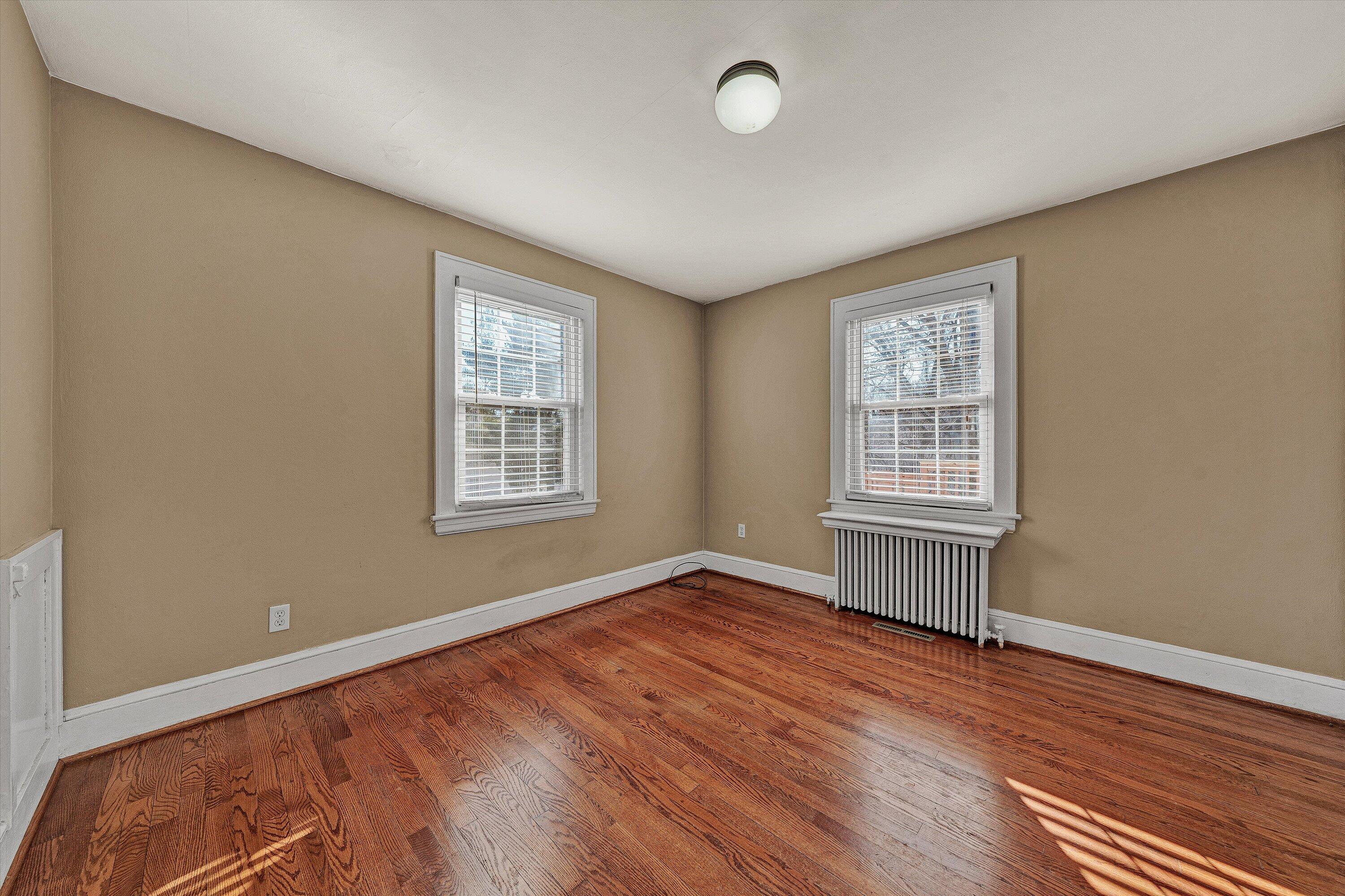 810 Windsor Avenue Southwest Roanoke, VA 24015 - Photo 10 of 21 an empty room with wooden floor and windows