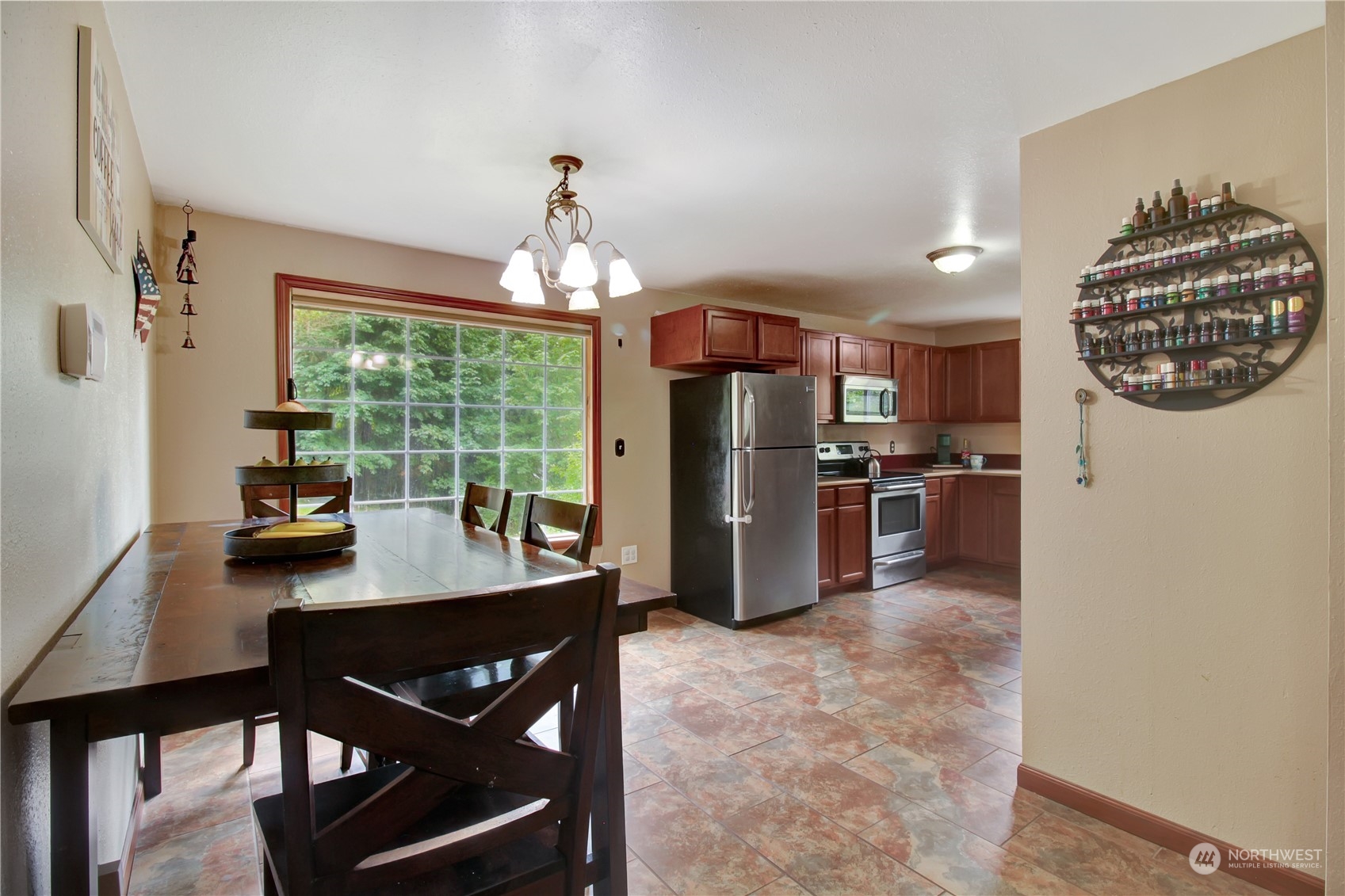 2009 South Lake Roesiger Road Snohomish, WA 98290 - Photo 7 of 39 a kitchen with stainless steel appliances granite countertop a refrigerator a sink dishwasher a stove a dining table and chairs with wooden floor