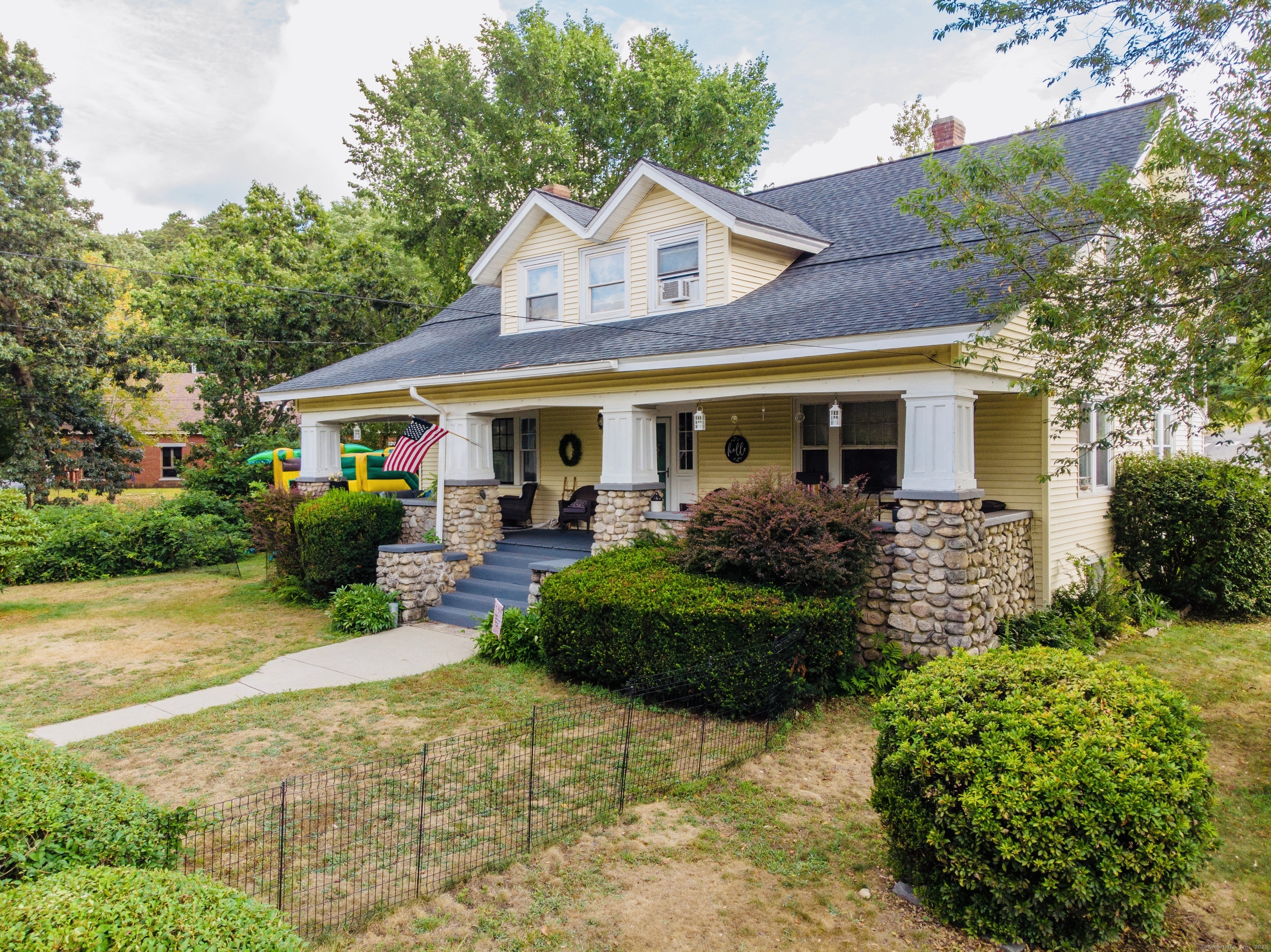 a front view of a house with garden
