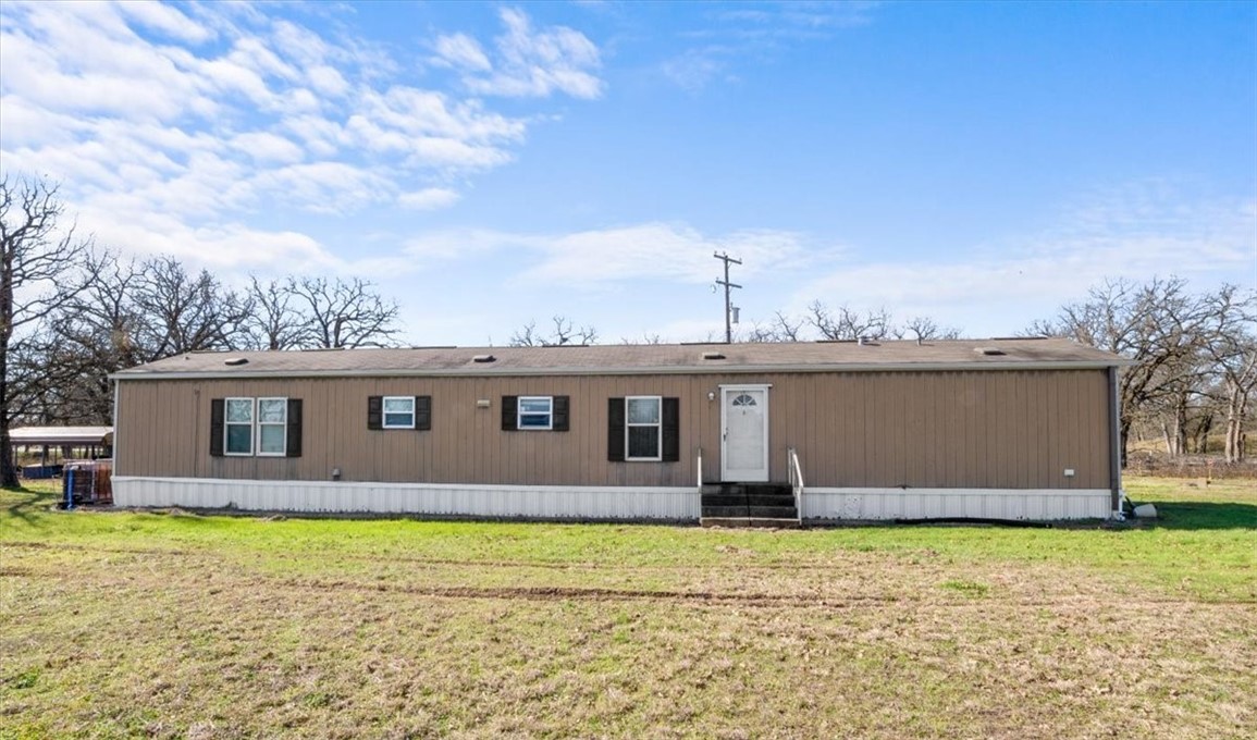 a front view of house with yard and entertaining space