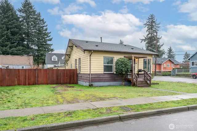 a view of a house with a yard and sitting area