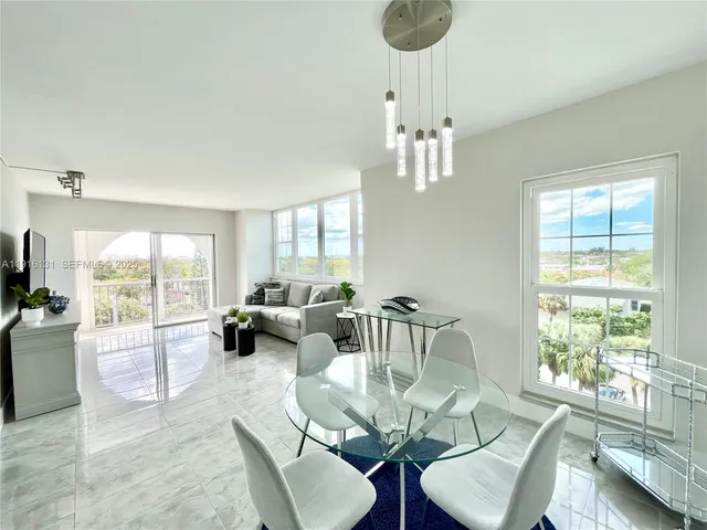 a living room with furniture or couch and a large window