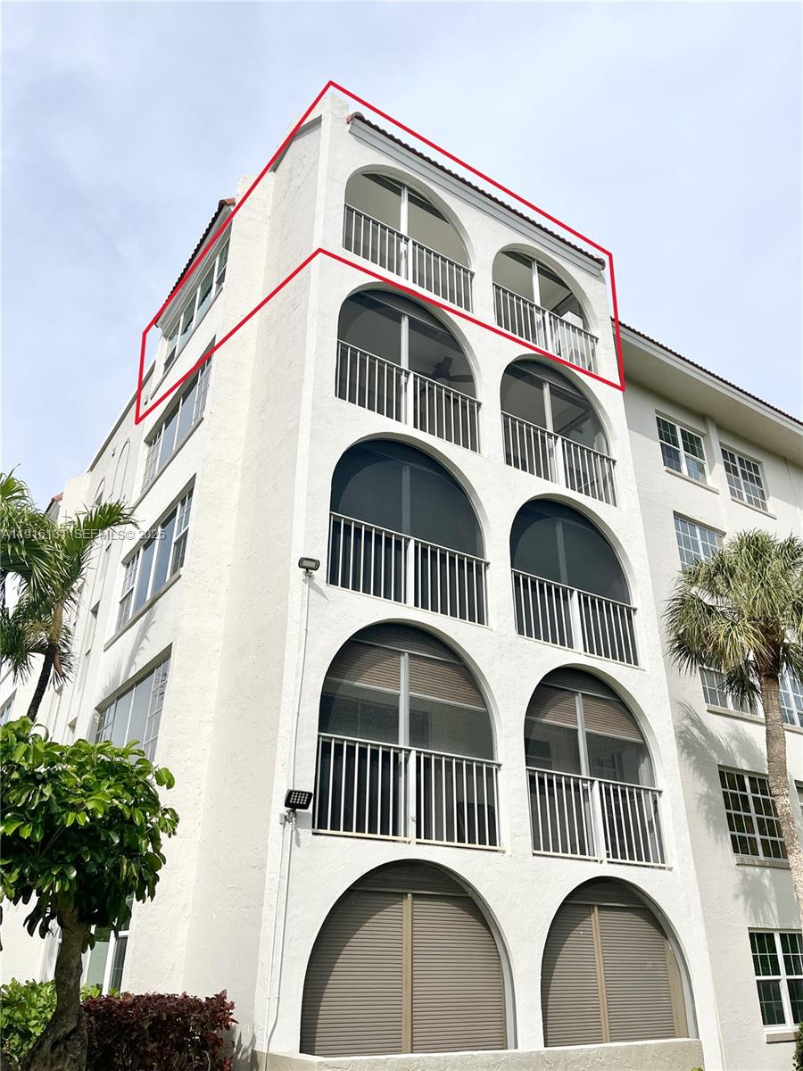 250 Northeast 20th Street, Unit 5250 Boca Raton, FL 33431 - Photo 17 of 19 a front view of a house with garage