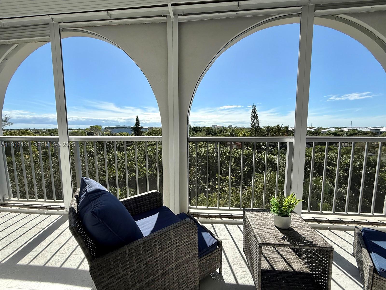 250 Northeast 20th Street, Unit 5250 Boca Raton, FL 33431 - Photo 3 of 19 a view of balcony with couch and chairs