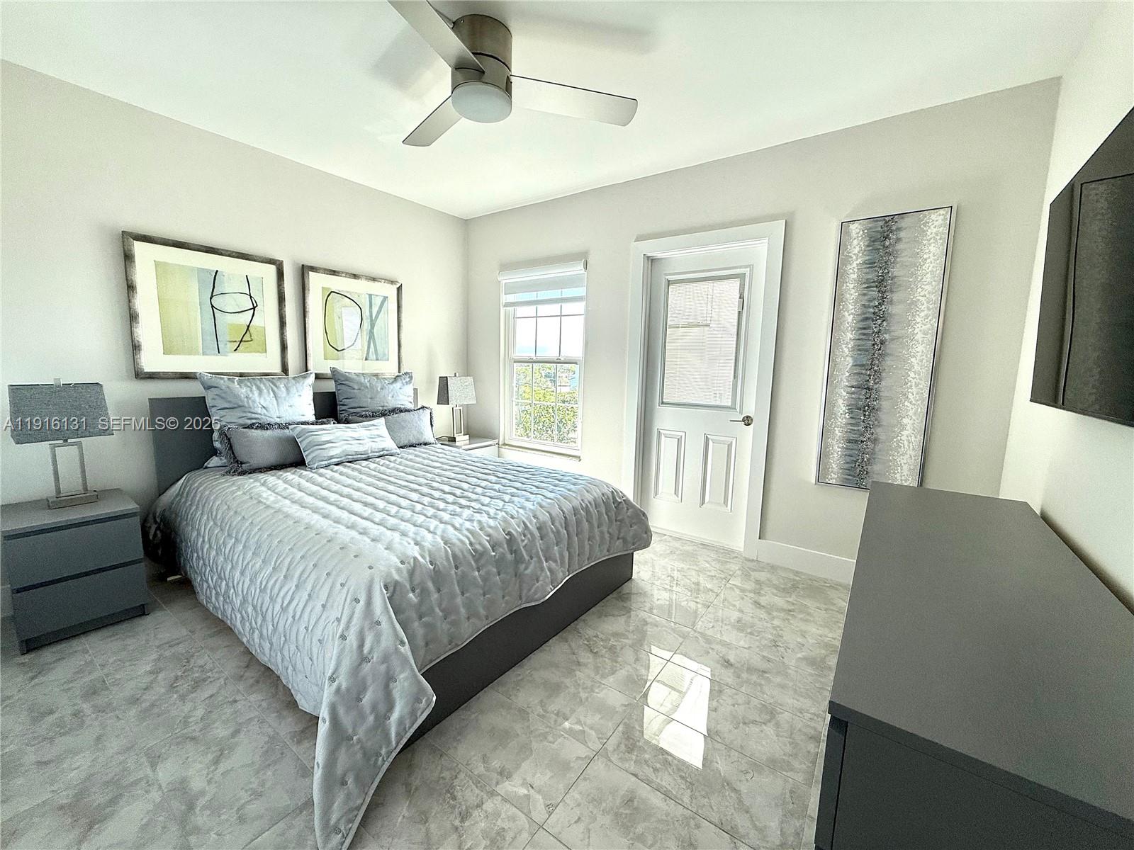 250 Northeast 20th Street, Unit 5250 Boca Raton, FL 33431 - Photo 5 of 19 a bedroom with a large bed and a window
