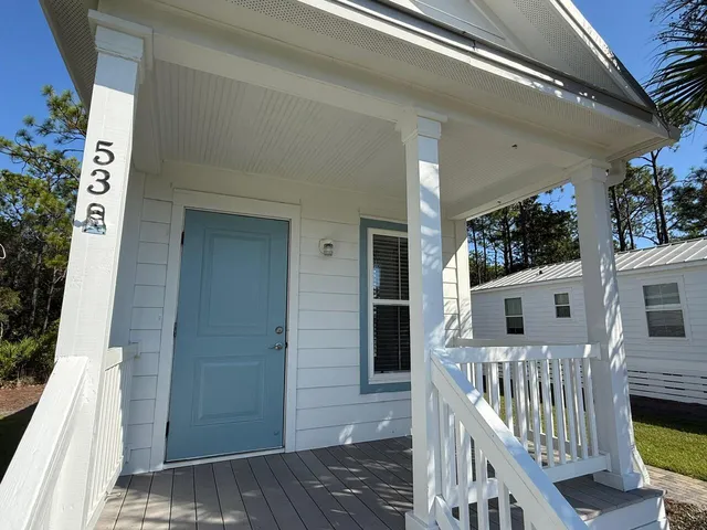 a kitchen with stainless steel appliances granite countertop a refrigerator a stove a sink dishwasher and a refrigerator with wooden floor