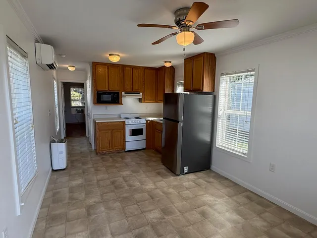 a kitchen with a refrigerator stove and microwave