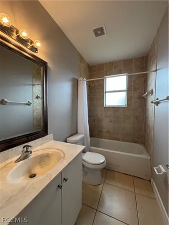 a bathroom with a sink mirror toilet and bathtub