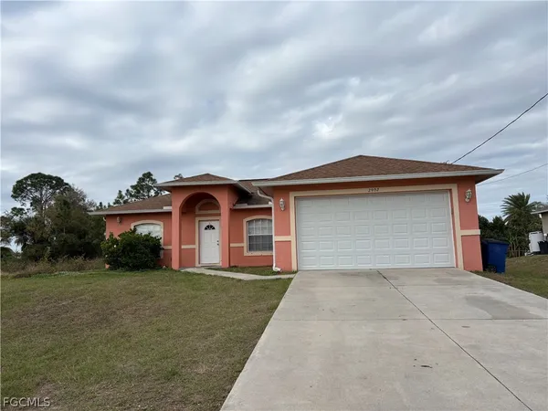 a front view of a house with a yard and garage