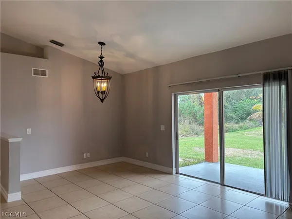 a view of a livingroom with a ceiling fan & window