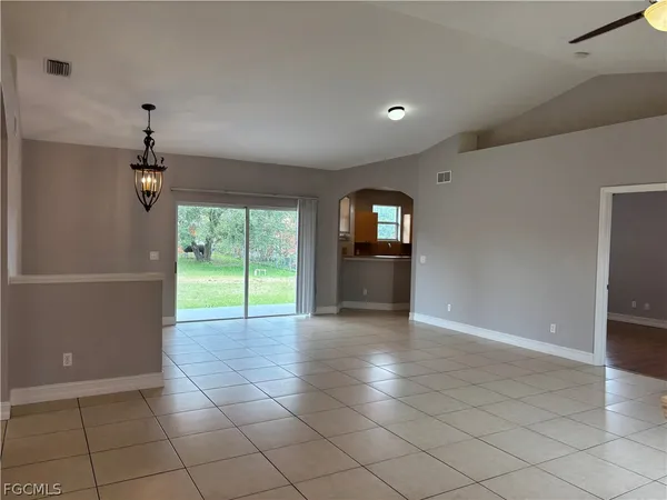 a view of a livingroom with a ceiling fan and window